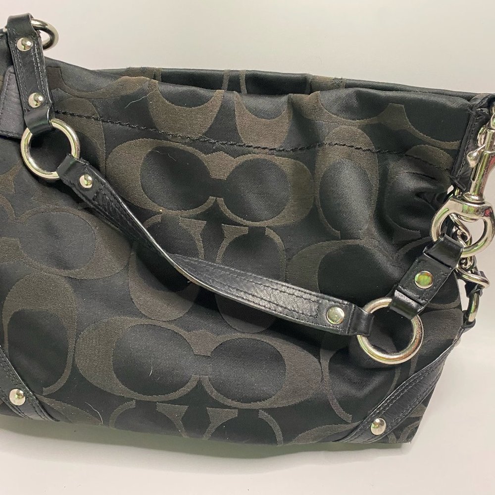 Small COACH Black hobo style tote with purple liner.